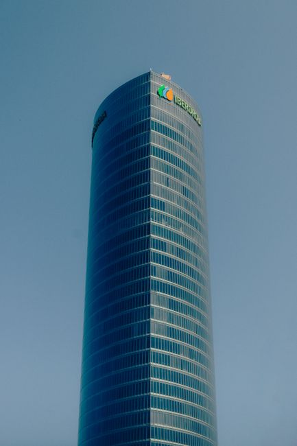 Stunning view of the Iberdrola Tower in Bilbao with a clear blue sky backdrop.