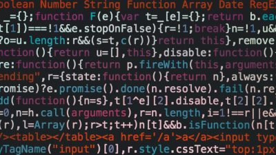 Close-up of colorful coding text on a dark computer screen, representing software development.